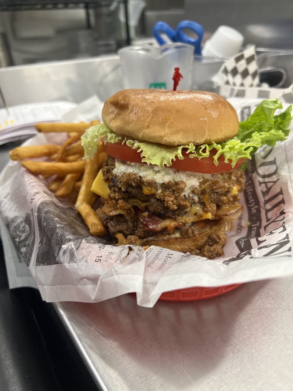 Burger plate beside a cold milkshake.